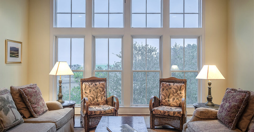 A living room with four large double-hung replacement windows.
